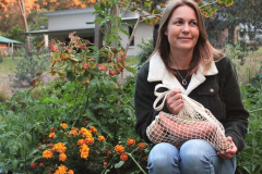 Joanna in front of her veggie garden at home