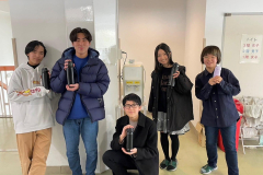 Students posing with their reusable water bottles in front of their new water dispenser. (Photo Credit: Kokoro Kawai)