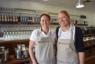 two women with aprons in a bulk food store