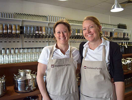 two women with aprons in a bulk food store