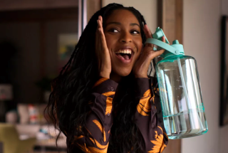 Girl holding a reusable water bottle to Flip the Script on Plastics