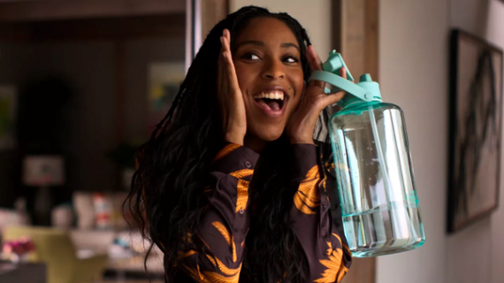 Girl holding a reusable water bottle to Flip the Script on Plastics